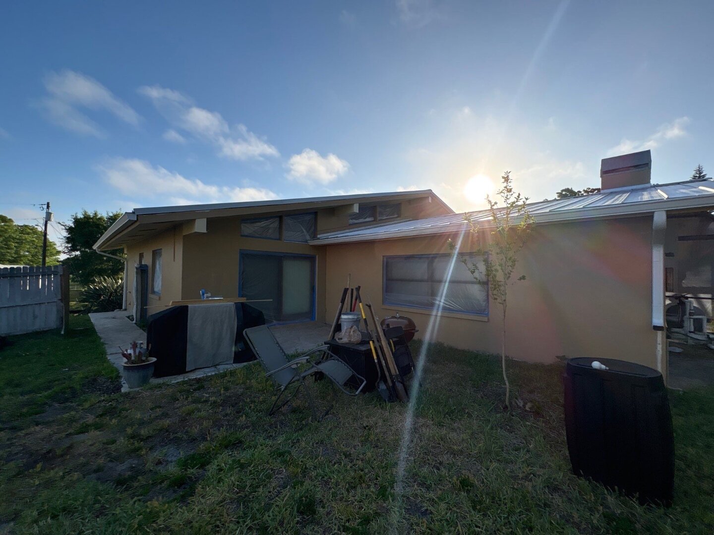 Dunedin home backyard exterior before painting with original brown and tan finish